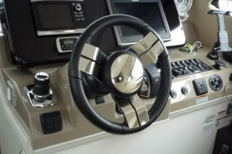  Yacht Photos Pics Steering wheel and controls of a 2017 Carver C37 yacht cockpit.