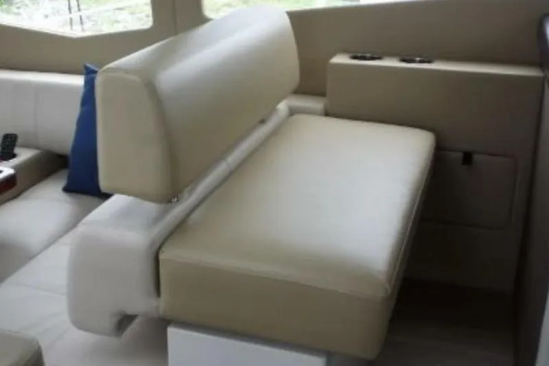  Yacht Photos Pics Interior seating of 2017 Carver C37 yacht, featuring beige upholstery and cup holders.