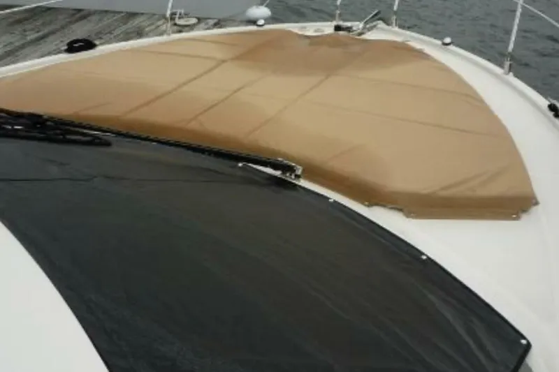  Yacht Photos Pics 2017 Carver C37 yacht with tan cover on deck, docked by the water.