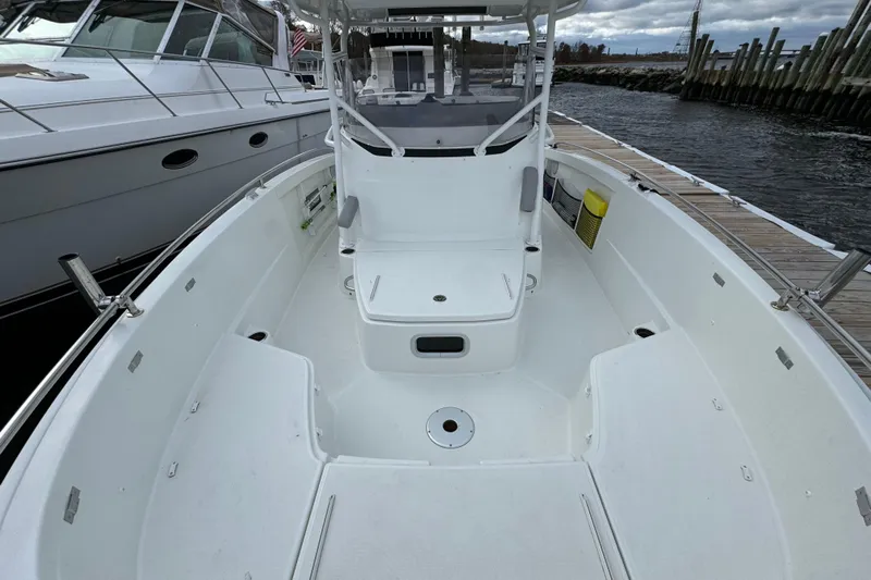  Yacht Photos Pics 2023 Jeanneau Leader 9.0 CC boat interior, docked, showcasing spacious seating and helm area.