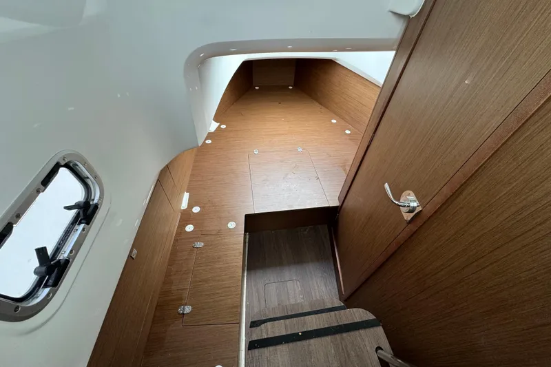  Yacht Photos Pics 2023 Jeanneau Leader 9.0 CC cabin interior with wood finish and window view.