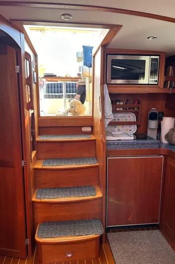 Bravo Yacht Photos Pics Interior of 2005 Sabre 42 Hardtop Express with wooden stairs and kitchenette.