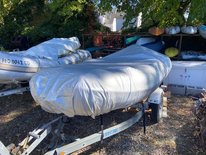 Bravo Yacht Photos Pics Covered boat on trailer, surrounded by trees and other boats. Sabre 42 Hardtop Express, 2005.