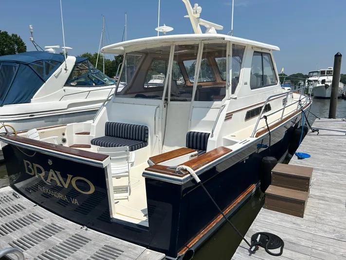 Bravo Yacht Photos Pics 2005 Sabre 42 Hardtop Express yacht docked, featuring elegant design and spacious seating.