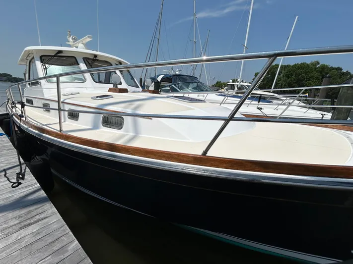 Bravo Yacht Photos Pics 2005 Sabre 42 Hardtop Express yacht docked, showcasing sleek design and polished railings.