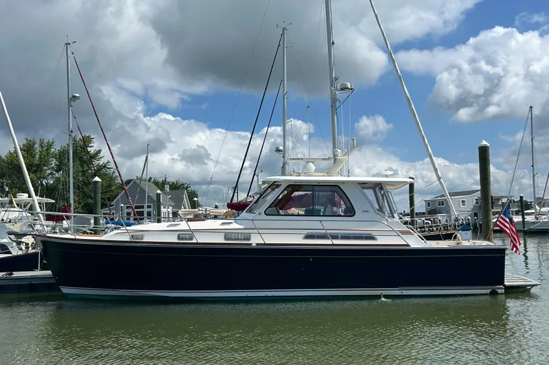 Bravo Yacht Photos Pics 2005 Sabre 42 Hardtop Express yacht docked in a marina under cloudy skies.