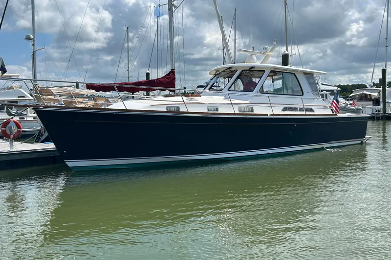 Bravo Yacht Photos Pics 2005 Sabre 42 Hardtop Express yacht docked in a marina under cloudy skies.