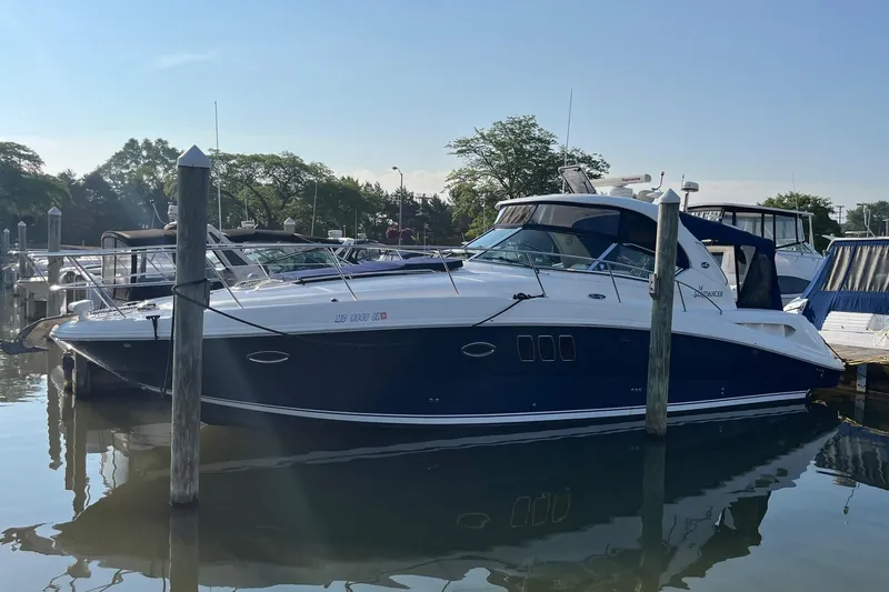 Sonship Yacht Photos Pics 2006 Sea Ray 380 Sundancer yacht docked in a marina, reflecting on calm water.