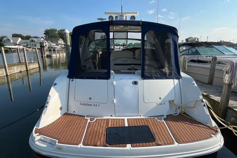 Sonship Yacht Photos Pics 2006 Sea Ray 380 Sundancer docked at marina, rear view with blue canopy.