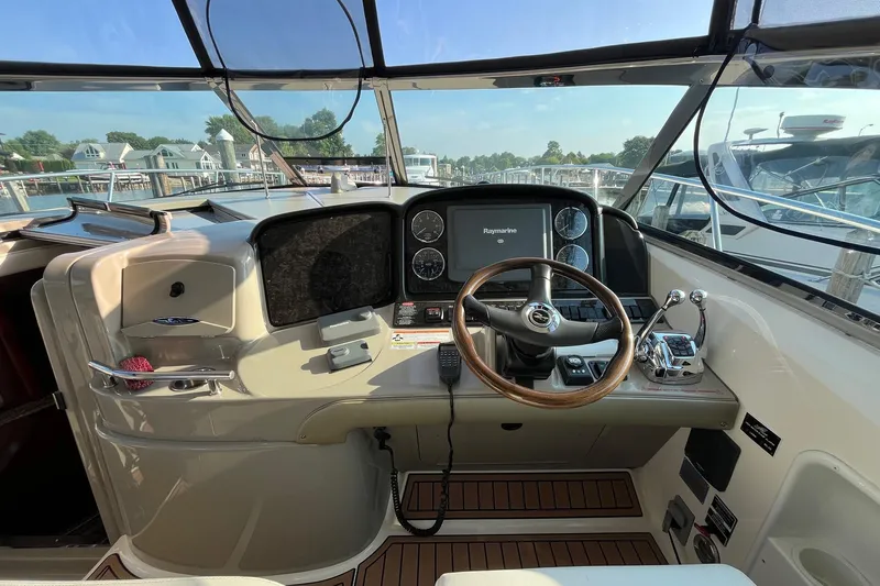 Sonship Yacht Photos Pics Helm of 2006 Sea Ray 380 Sundancer with steering wheel and navigation controls.