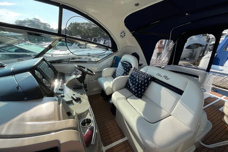 Sonship Yacht Photos Pics 2006 Sea Ray 380 Sundancer cockpit with luxurious seating and modern dashboard.