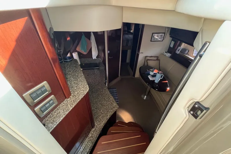 Sonship Yacht Photos Pics Interior of 2006 Sea Ray 380 Sundancer yacht with modern kitchen and seating area.