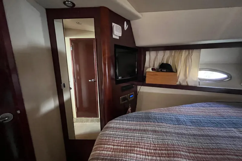 Sonship Yacht Photos Pics Cozy cabin interior of 2006 Sea Ray 380 Sundancer with bed, TV, and porthole window.