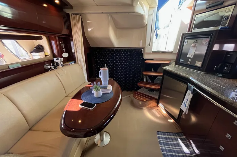 Sonship Yacht Photos Pics Interior of 2006 Sea Ray 380 Sundancer yacht with elegant seating and kitchenette.
