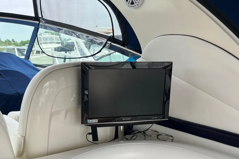 Sonship Yacht Photos Pics Interior of 2006 Sea Ray 380 Sundancer with mounted Sharp TV and white seating.