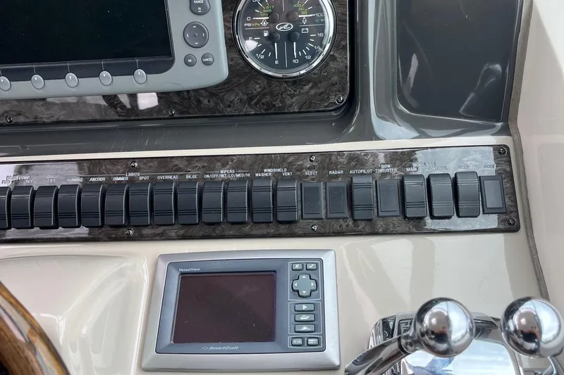 Sonship Yacht Photos Pics Control panel of a 2006 Sea Ray 380 Sundancer boat with switches and gauges.