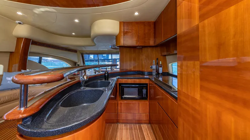  Yacht Photos Pics Luxurious kitchen interior of 2007 Azimut 62 Flybridge yacht with wood finish and modern amenities.