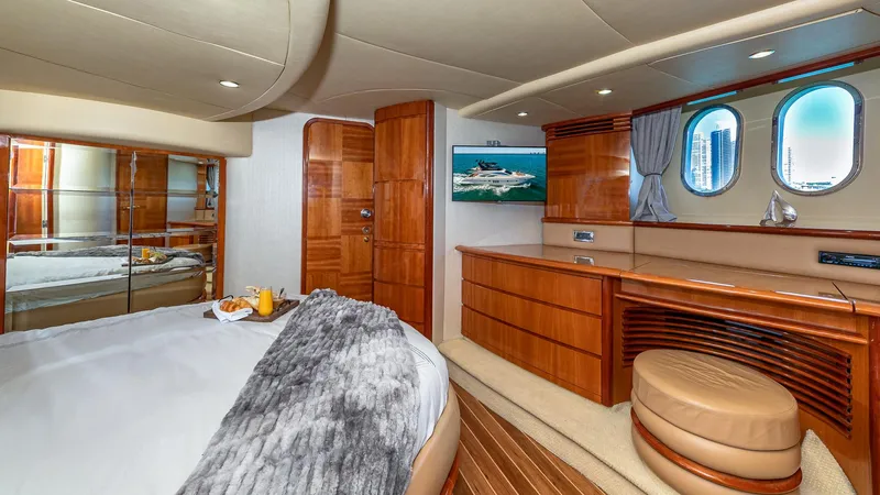  Yacht Photos Pics Luxurious 2007 Azimut 62 Flybridge yacht bedroom with elegant wood finishes and cozy decor.