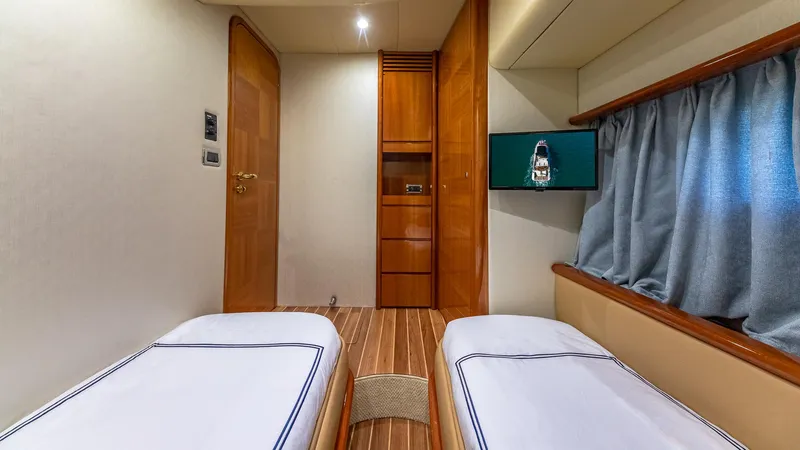  Yacht Photos Pics Interior of 2007 Azimut 62 Flybridge yacht with twin beds and wooden accents.