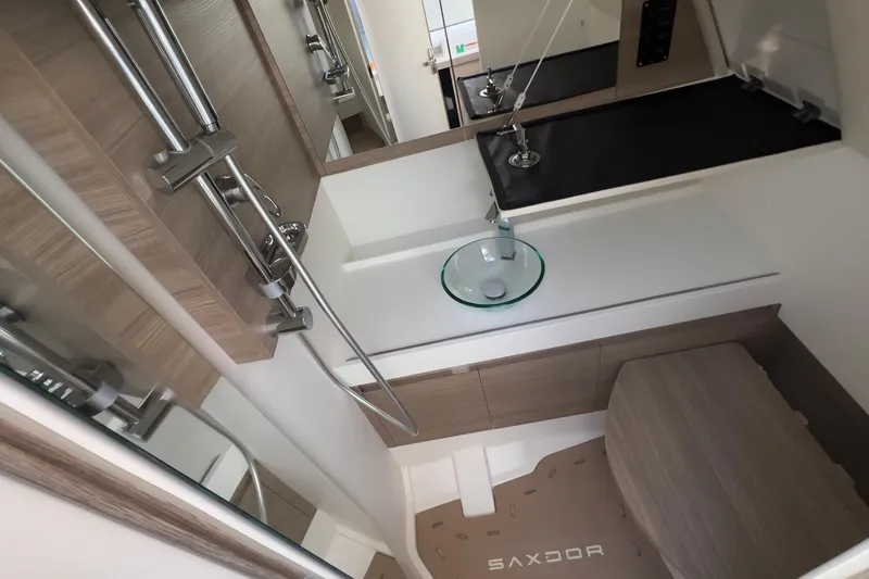  Yacht Photos Pics Modern bathroom interior of 2025 Saxdor 400 GTC boat, featuring sleek fixtures and wood accents.