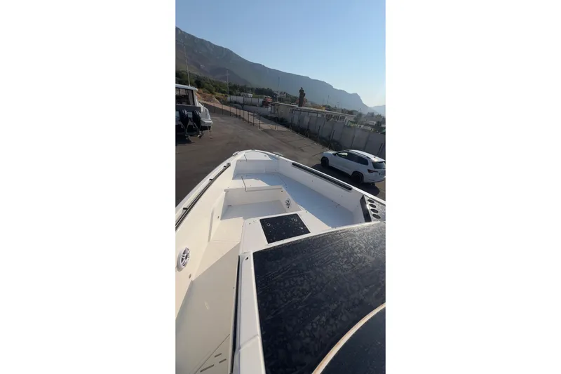  Yacht Photos Pics 2025 Saxdor 400 GTC boat deck view with mountains in the background.