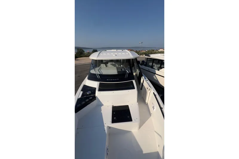  Yacht Photos Pics 2025 Saxdor 400 GTC boat, sleek design, docked under clear blue sky.