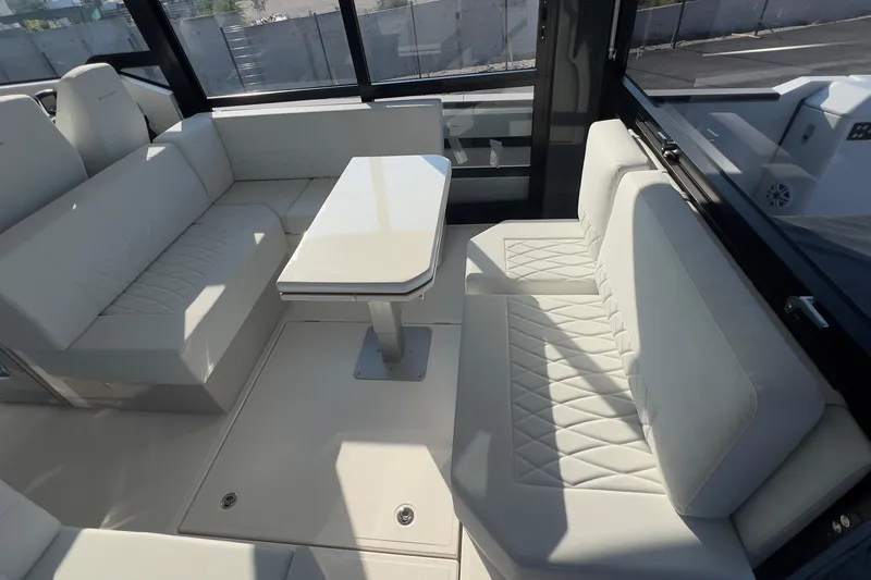 Yacht Photos Pics Luxurious interior of 2025 Saxdor 400 GTC yacht with elegant white seating and table.