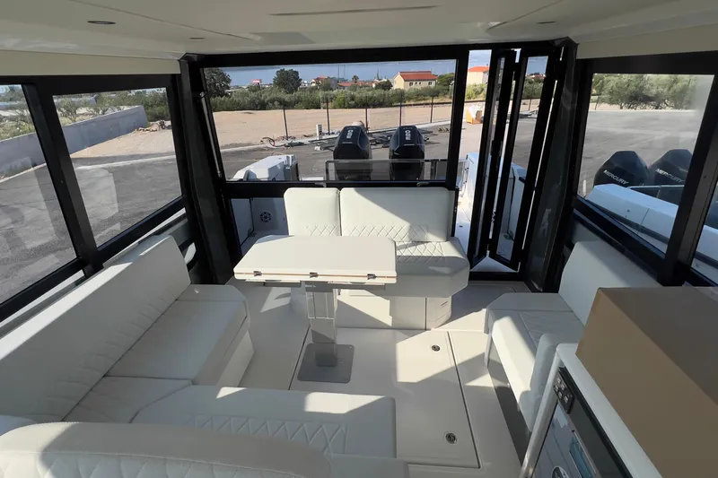  Yacht Photos Pics Interior of 2025 Saxdor 400 GTC boat with modern seating and table arrangement.