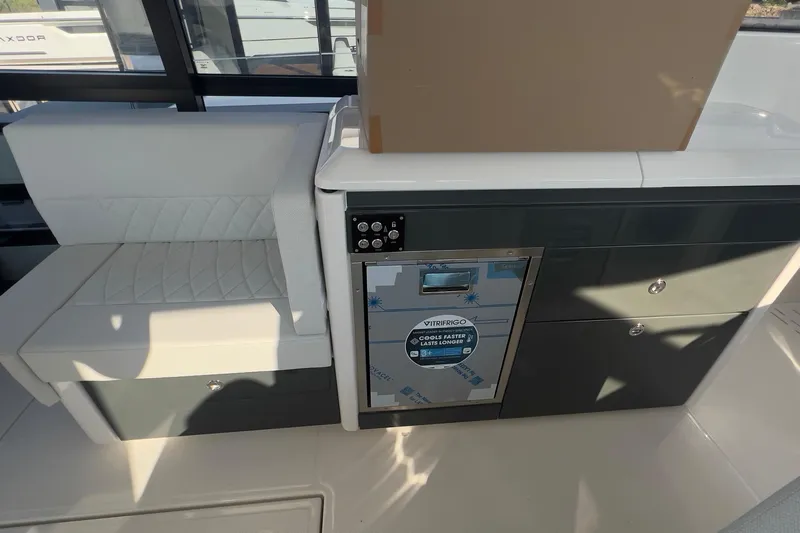  Yacht Photos Pics Interior of 2025 Saxdor 400 GTC featuring seating and a compact refrigerator.
