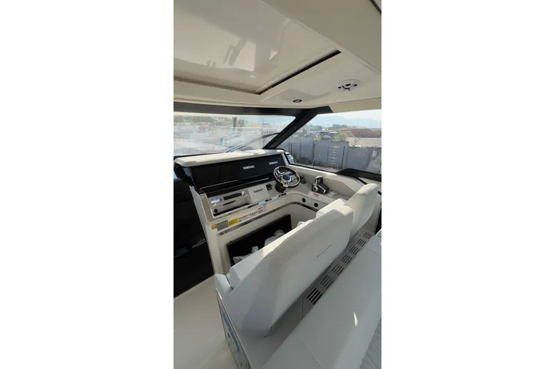  Yacht Photos Pics Interior of 2025 Saxdor 400 GTC boat, featuring modern helm and seating.