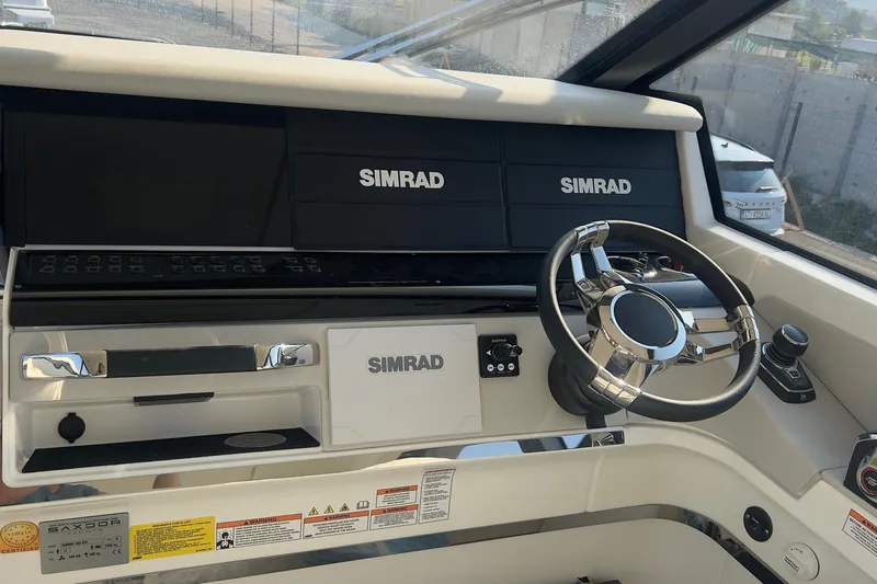  Yacht Photos Pics Cockpit of 2025 Saxdor 400 GTC with Simrad navigation system and modern steering wheel.