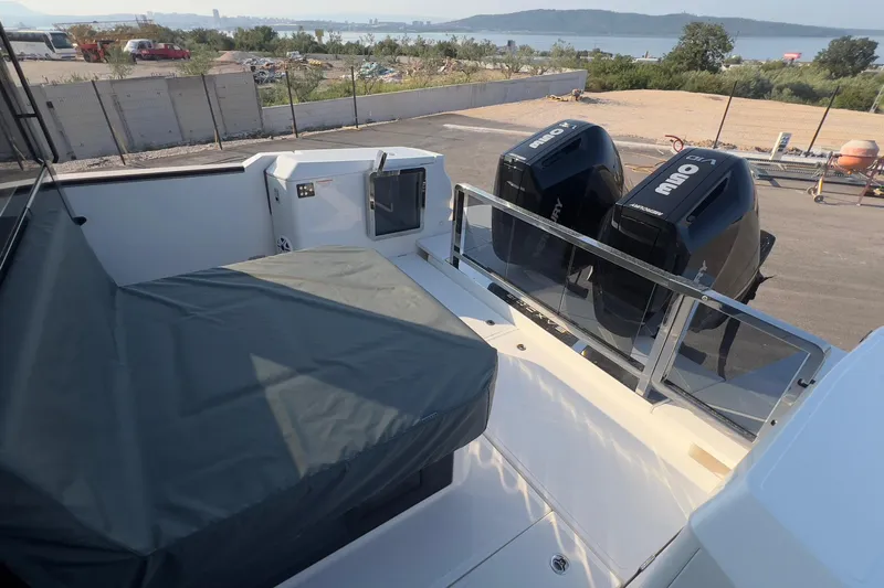  Yacht Photos Pics 2025 Saxdor 400 GTC boat with dual Mercury outboard engines, docked near a scenic waterfront.