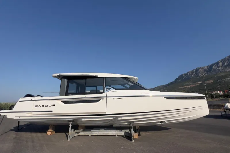  Yacht Photos Pics 2025 Saxdor 400 GTC boat on display against a mountainous backdrop.