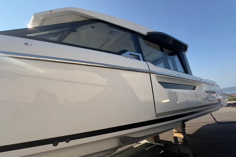  Yacht Photos Pics 2025 Saxdor 400 GTC boat, sleek design, docked under clear blue sky.