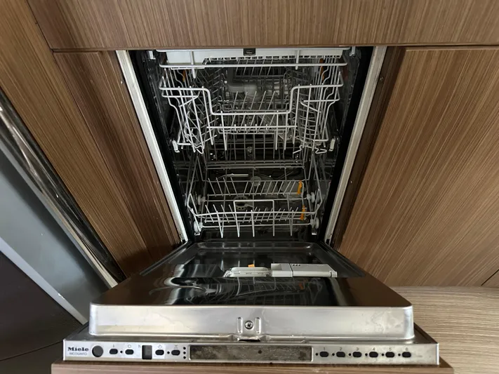  Yacht Photos Pics Open Miele dishwasher in a wooden kitchen setting on a 2005 Riva 52 Rivale yacht.