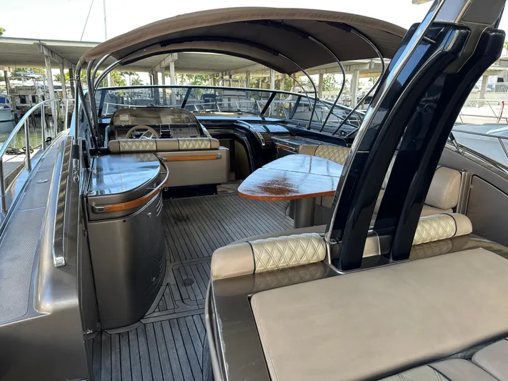  Yacht Photos Pics Luxurious 2005 Riva 52 Rivale yacht interior with elegant seating and wooden table.