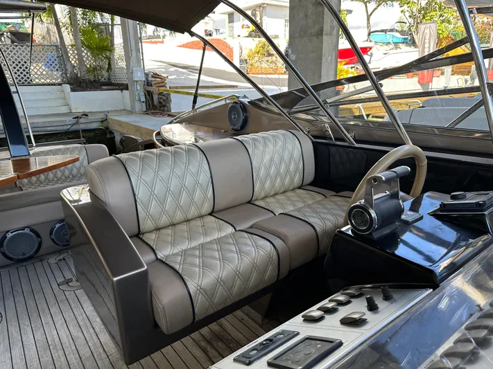  Yacht Photos Pics Luxurious interior of a 2005 Riva 52 Rivale yacht with plush seating and sleek controls.