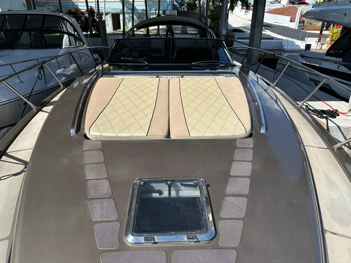  Yacht Photos Pics 2005 Riva 52 Rivale yacht with sunbathing cushions and sleek deck design.