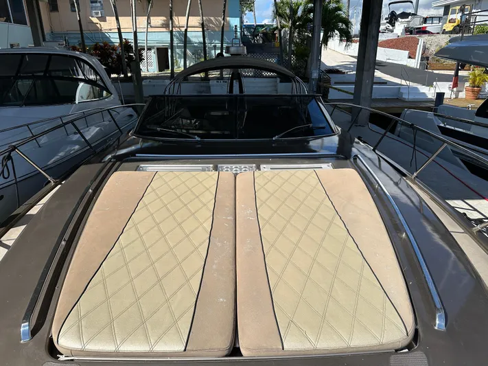  Yacht Photos Pics 2005 Riva 52 Rivale yacht with beige cushioned deck, docked in a marina.