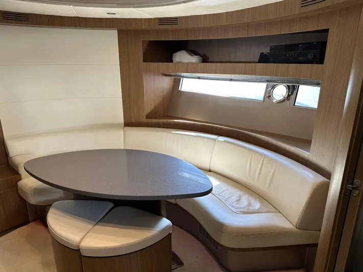  Yacht Photos Pics Interior of 2005 Riva 52 Rivale yacht with curved seating and table.