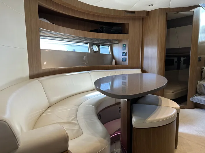  Yacht Photos Pics Interior of 2005 Riva 52 Rivale yacht with curved seating and table.