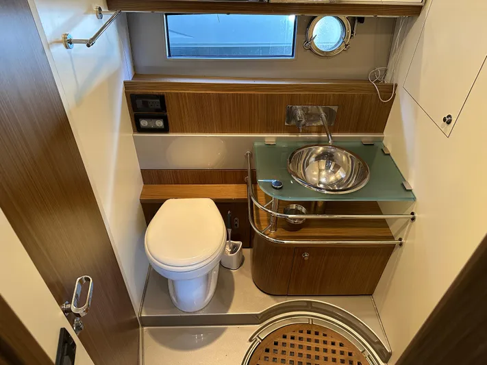  Yacht Photos Pics Luxurious bathroom in a 2005 Riva 52 Rivale yacht, featuring modern fixtures and wood accents.
