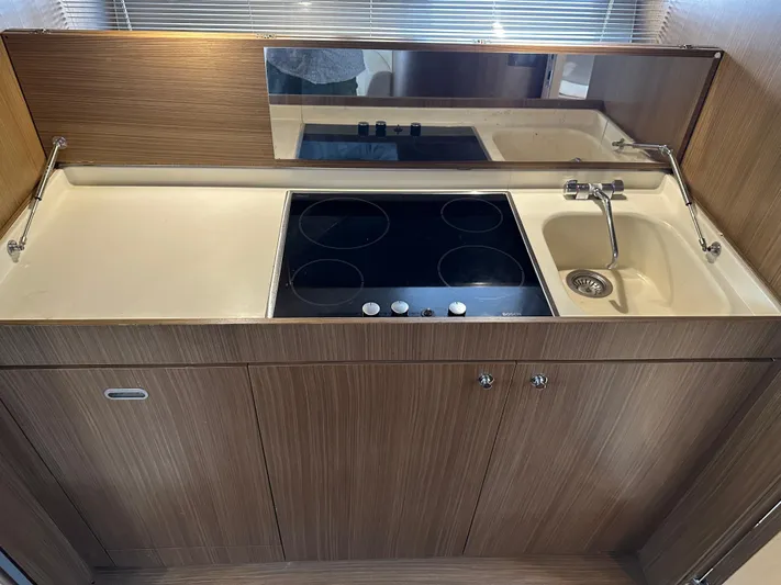  Yacht Photos Pics Kitchen area of a 2005 Riva 52 Rivale yacht with stove and sink.