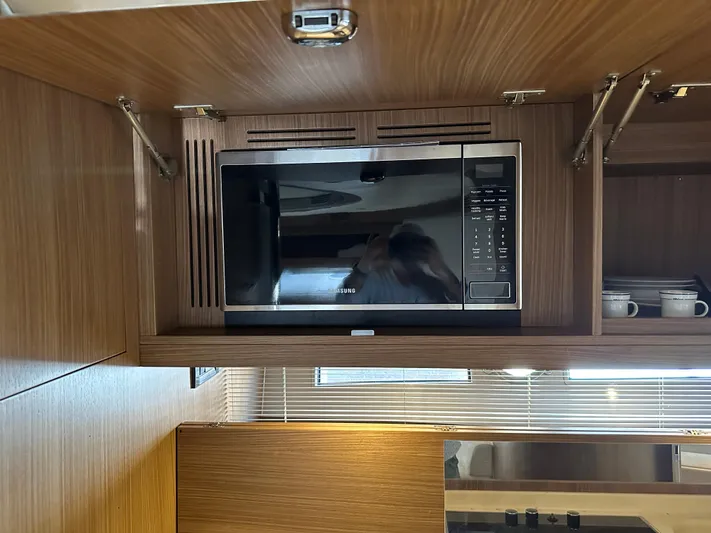  Yacht Photos Pics Microwave in 2005 Riva 52 Rivale yacht kitchen with wooden cabinetry.