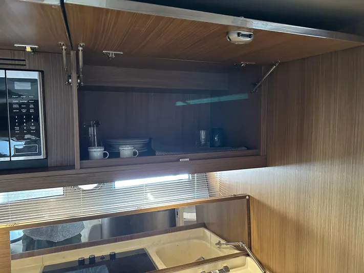  Yacht Photos Pics Wooden kitchen cabinet with open shelves in a 2005 Riva 52 Rivale yacht.