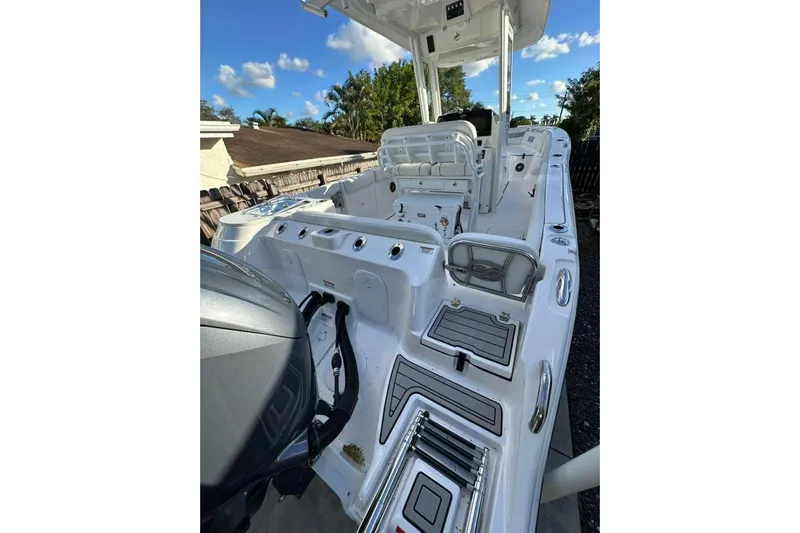  Yacht Photos Pics 2024 Sea Fox 268 Commander boat interior with seating and controls, under a clear blue sky.