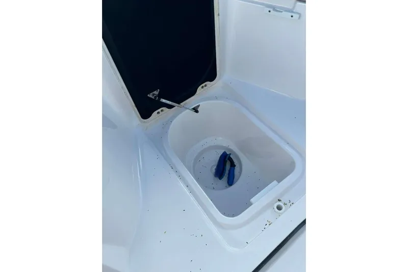  Yacht Photos Pics 2024 Sea Fox 268 Commander storage compartment with open lid and blue tool inside.