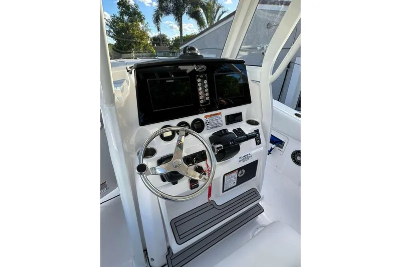  Yacht Photos Pics 2024 Sea Fox 268 Commander helm with steering wheel and navigation controls.