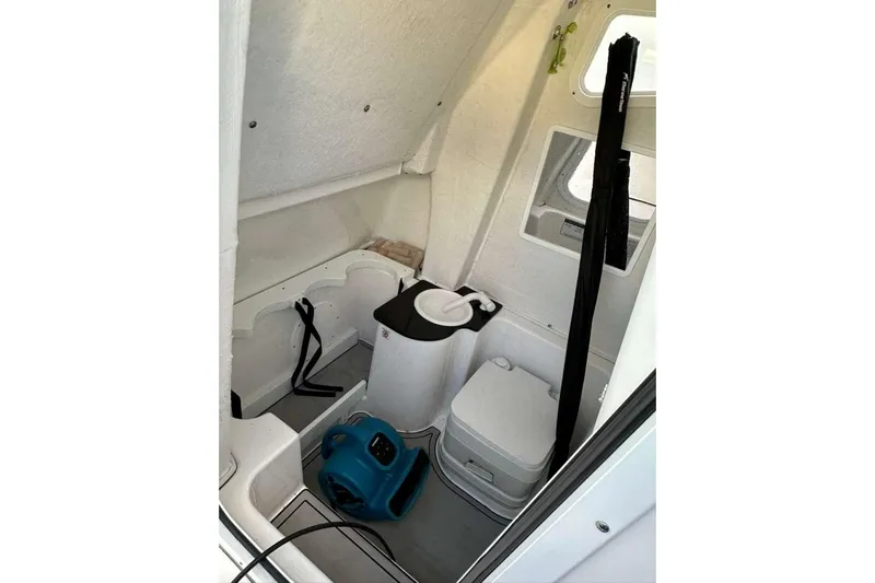  Yacht Photos Pics 2024 Sea Fox 268 Commander cabin interior with portable toilet and storage.