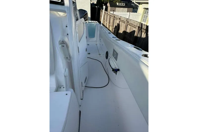  Yacht Photos Pics 2024 Sea Fox 268 Commander boat interior, showcasing sleek white deck and storage compartments.